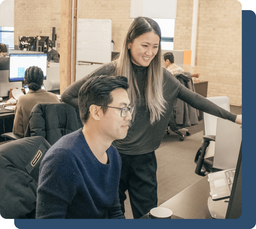 Team members are discussing a project on a laptop screen.